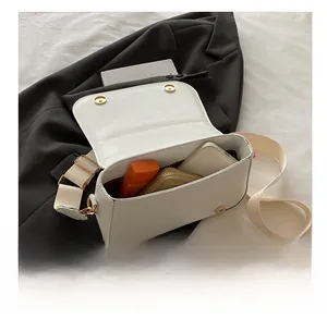 Interior view of white leather crossbody bag showing capacity for phone and wallet