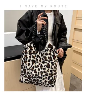 Detail of plush leopard print tote bag featuring woven rope handles and soft texture