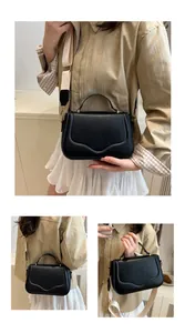 Detail of black matte saddle bag with wavy stitching and wide cream fabric strap