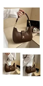 Close-up of retro brown half-moon bag featuring gold metal buckle and leather texture