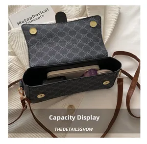 Internal view of the printed crossbody bag showing storage for phone and cosmetics