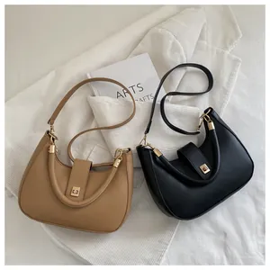 Detail of crescent crossbody bags in khaki and black leather with gold twist locks