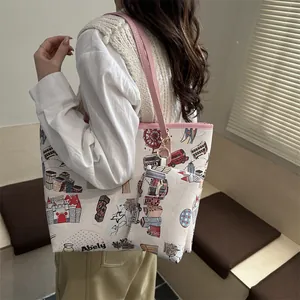 Fashionable London doodle print tote bag with pink straps and a matching small pouch