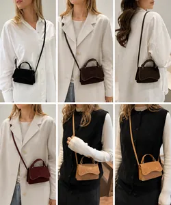 Detail view of mini vintage suede crossbody bags in black, brown, wine, and camel colors