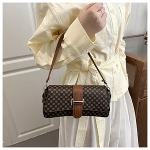 Close-up of vintage brown patterned shoulder bag with premium golden metal buckle and leather strap