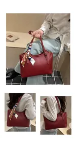Detail of burgundy tote bag featuring white stitching and vintage patterned scarf wrap