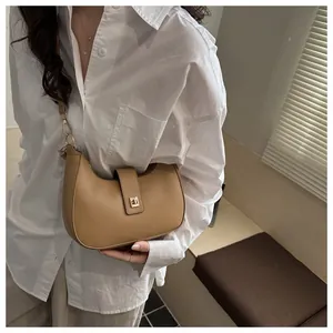 Khaki crescent moon shoulder bag featuring a sleek golden twist lock and thin leather strap