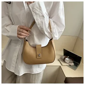 Detail of camel leather crescent hobo bag with metal buckle and fixed top handle