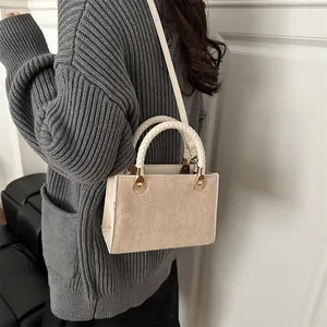 Retro beige embossed crossbody bag with woven handle and elegant floral patterns