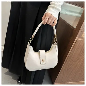 Detail showing high-quality synthetic leather texture and gold metal buckle on hobo bag