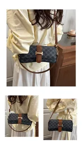 Close-up detail of vintage pattern shoulder bag with brown leather trim and golden buckle