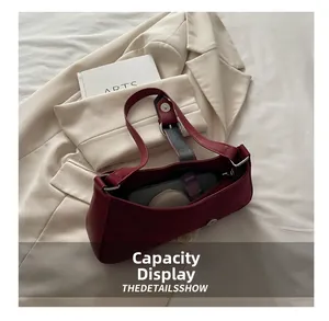 Top view of deep red leather shoulder bag showing large capacity for daily essentials