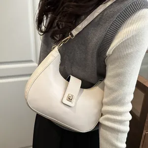 Minimalist white crescent moon shoulder bag with golden buckle and zipper closure