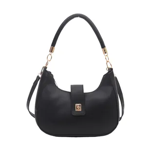 Elegant black crescent hobo bag with golden hardware and adjustable shoulder strap