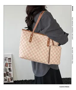 Detail of light brown tote bag with letter jacquard pattern and matching small pouch