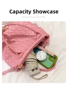 Pink woven handbag capacity display showing items like a phone and umbrella inside