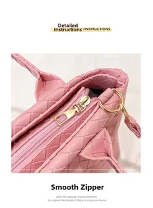 Detailed close-up of smooth pink zipper and woven texture on the large Boston bag