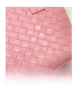 Macro detail of high-quality pink leather woven texture and artisan checkered craftsmanship