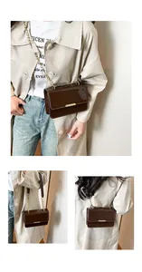 Detail view of dark coffee patent leather crossbody bag with elegant gold metal chain strap
