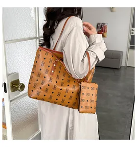Detail of printed brown tote bag with matching coin purse and stylish bear pattern