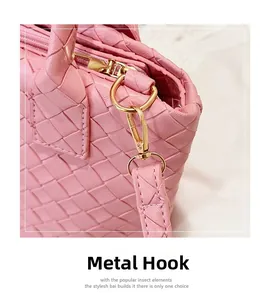 Detailed close-up of premium gold-toned metal hook on a pink woven shoulder handbag