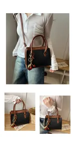 Detail of color-block tote with cherry charm and gold lettering on lychee texture leather