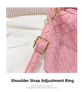 Detail of adjustable shoulder strap and gold hardware on pink woven texture handbag