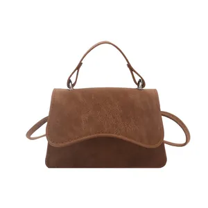 Brown vintage faux leather crossbody bag with top handle and pebble grain texture