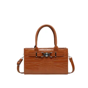 Brown crocodile embossed tote bag with silver heart buckle and adjustable strap