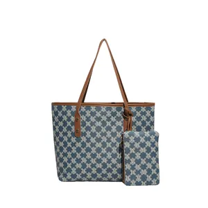 Blue and white jacquard tote bag with leather straps and matching small zipper pouch