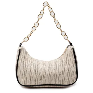 Chic cream straw crescent bag with black leather piping and gold chain strap for beach