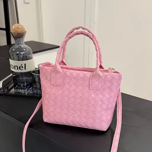 Pink woven leather Boston bag with dual top handles and detachable shoulder strap