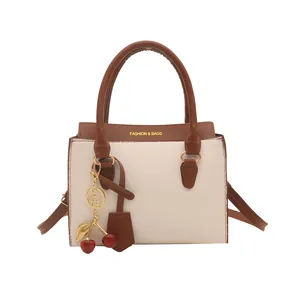 Retro color-block crossbody square handbag with cherry pendant and leather texture