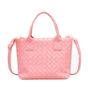 Pink woven Intrecciato style tote bag with top handles and adjustable shoulder strap