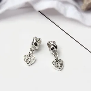 Silver vintage heart earrings with Elizabeth II relief and twisted hoop detail