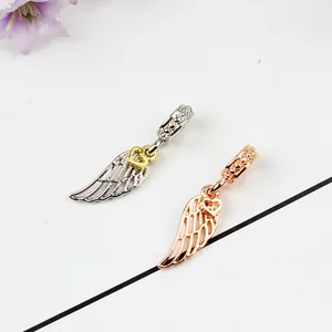 Detail of angel wing heart pendants in silver and rose gold for DIY bead jewelry