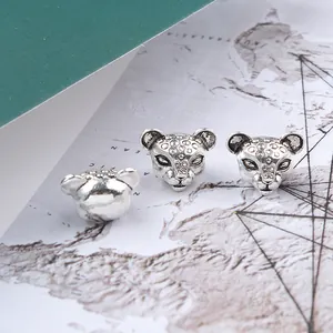 Detailed macro view of silver leopard animal charms for jewelry making with vintage finish