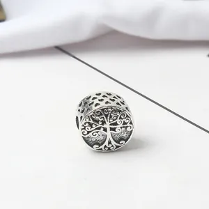 Macro view of vintage silver hollow heart design with Tree of Life engraving charm