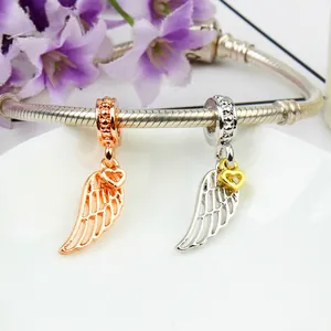 Polished angel wing pendants with heart charm on a metal snake chain bracelet