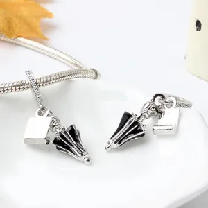 Silver umbrella charm with black enamel and zircon-set tag for beaded bracelets