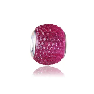 Macro shot of pink resin candy beads with large holes and faceted crystals for DIY jewelry