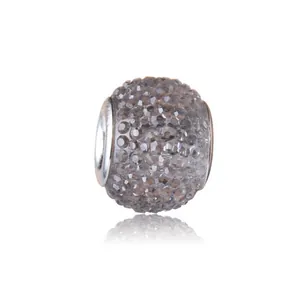 Macro shot of barrel-shaped charm with gray micro-pave crystals and silver metal base