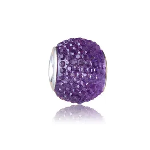 Macro view of purple faceted crystal pavé charm bead with a silver metallic core