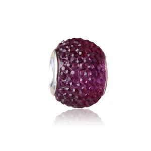 Detailed view of a purple crystal charm bead with silver core for DIY bracelets