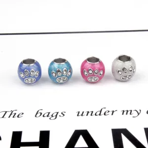 Enamel pet paw print charms with sparkling rhinestones in blue, pink, and silver for DIY jewelry