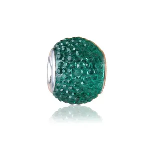 Detail of faceted green resin candy bead with a large silver hole for DIY bracelets