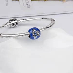 Silver snake chain bracelet with blue enamel paw print charm and barrel clasp