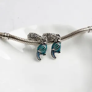 Tropical parrot charm set with teal enamel and zircons on a silver snake chain bracelet