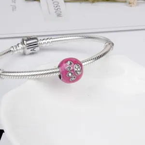 Silver snake chain bracelet with pink enamel dog paw print charm and sparkling zircon