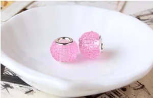 Macro shot of pink stardust resin beads with large metal holes for DIY charm bracelets